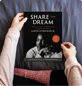 Hands holding Share the Dream book